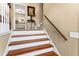 Elegant staircase with wooden steps, white risers, and a classic wooden handrail at 13 Greystone Nw Ln, Cartersville, GA 30121