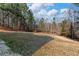 Large backyard and heavily wooded perimeter provide a secluded outdoor area at 134 Paces Lakes Overlook, Dallas, GA 30157