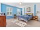 Bright bedroom with a window, neutral carpet, and white and blue painted walls at 134 Paces Lakes Overlook, Dallas, GA 30157