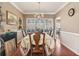 Formal dining room featuring hardwood floors, wainscoting, and a classic chandelier at 134 Paces Lakes Overlook, Dallas, GA 30157