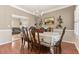 Formal dining room with hardwood floors, elegant chandelier, and ample seating at 134 Paces Lakes Overlook, Dallas, GA 30157