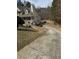 Two-story home with a covered front porch, long driveway, and mature trees at 134 Paces Lakes Overlook, Dallas, GA 30157