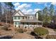 Charming two-story home with a welcoming porch and beautifully landscaped front yard and long driveway at 134 Paces Lakes Overlook, Dallas, GA 30157
