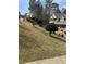Charming two-story home with landscaped yard, green grass, and mature trees at 134 Paces Lakes Overlook, Dallas, GA 30157