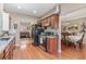 Modern kitchen featuring wood cabinets and stainless steel appliances, adjacent to breakfast and dining areas at 134 Paces Lakes Overlook, Dallas, GA 30157
