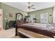Main bedroom featuring a king sized bed, ceiling fan, and large dresser at 134 Paces Lakes Overlook, Dallas, GA 30157