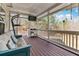 Screened back porch with a couch and ceiling fan overlooking the woods at 134 Paces Lakes Overlook, Dallas, GA 30157