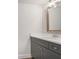 Modern half-bath featuring a gray vanity with granite countertop, a brushed metal faucet, and contemporary lighting at 306 Bunker Hill Ct, Acworth, GA 30102