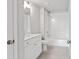 Clean bathroom with white vanity, toilet, and shower-tub combo with tile surround at 306 Bunker Hill Ct, Acworth, GA 30102