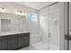 Modern bathroom with white tiled shower, bench seating, and gray vanity with double sinks at 306 Bunker Hill Ct, Acworth, GA 30102