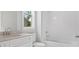 Bright bathroom featuring a white vanity with cultured marble countertop, subway tile, and shower-tub combination at 306 Bunker Hill Ct, Acworth, GA 30102