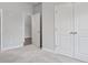 Bedroom with plush carpet, simple design, bright walls, and a double door closet, creating a cozy space at 306 Bunker Hill Ct, Acworth, GA 30102