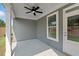 Relaxing covered patio features a ceiling fan, ample space, and a door that leads to the interior of the house at 306 Bunker Hill Ct, Acworth, GA 30102
