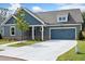 Charming home featuring a blue garage door, complemented by beautiful landscaping and a well-maintained lawn at 306 Bunker Hill Ct, Acworth, GA 30102