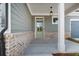 Charming front porch featuring brick accents, neutral siding, and a stylish entrance door, creating a welcoming space at 306 Bunker Hill Ct, Acworth, GA 30102