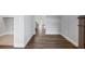 Hallway with wood-look flooring, white walls, and views to the kitchen and other rooms, offering a modern aesthetic at 306 Bunker Hill Ct, Acworth, GA 30102