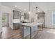 Beautiful kitchen with a large center island, gray cabinetry, modern appliances, and pendant lighting at 306 Bunker Hill Ct, Acworth, GA 30102