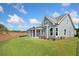 Beautiful home with a large, green lawn, modern siding, and a covered patio, ideal for enjoying the outdoors at 306 Bunker Hill Ct, Acworth, GA 30102