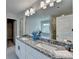 Bright bathroom features double sinks, granite counters, and a large mirror at 3328 Sir Gregory Mnr, Lawrenceville, GA 30044