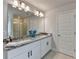 Well-lit bathroom featuring double sinks, granite countertops, and a glass shower at 3328 Sir Gregory Mnr, Lawrenceville, GA 30044