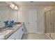 Well-lit bathroom featuring double sinks, granite countertops, and a glass shower at 3328 Sir Gregory Mnr, Lawrenceville, GA 30044