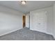 Neutral bedroom features gray carpet, a double door closet and an adjacent hallway at 3328 Sir Gregory Mnr, Lawrenceville, GA 30044