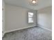 Neutral bedroom features gray carpet and a window providing ample natural light at 3328 Sir Gregory Mnr, Lawrenceville, GA 30044