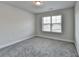 Neutral bedroom with a gray carpet and a window with natural light at 3328 Sir Gregory Mnr, Lawrenceville, GA 30044