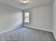 Cozy carpeted bedroom with a window allowing natural light at 3328 Sir Gregory Mnr, Lawrenceville, GA 30044
