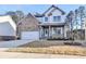 Beautiful two-story home featuring a brick facade, inviting front porch, and a well-manicured lawn at 3328 Sir Gregory Mnr, Lawrenceville, GA 30044