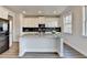 Bright kitchen with stainless steel appliances, black backsplash, and a large granite island at 3328 Sir Gregory Mnr, Lawrenceville, GA 30044