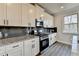 Bright kitchen featuring stainless steel appliances, granite counters, and dark backsplash at 3328 Sir Gregory Mnr, Lawrenceville, GA 30044