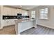 Bright kitchen with stainless steel appliances, black backsplash, and a large granite island at 3328 Sir Gregory Mnr, Lawrenceville, GA 30044