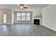 Bright living area with fireplace, hardwood floors, lots of natural light and neutral walls at 3328 Sir Gregory Mnr, Lawrenceville, GA 30044