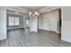 Open living area with hardwood floors, white trim and lots of natural light from the large window at 3328 Sir Gregory Mnr, Lawrenceville, GA 30044