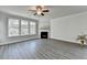 Light-filled living room boasts hardwood floors, a fireplace, and an abundance of windows at 3328 Sir Gregory Mnr, Lawrenceville, GA 30044