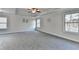 Spacious main bedroom with three windows, gray carpet, and tray ceiling at 3328 Sir Gregory Mnr, Lawrenceville, GA 30044