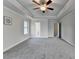 Spacious main bedroom with three windows, gray carpet, tray ceiling, and hallway entrances at 3328 Sir Gregory Mnr, Lawrenceville, GA 30044