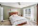 Bedroom with neutral carpet, ceiling fan, and a large window with sheer curtains at 83 Southshore Ln, Dallas, GA 30157