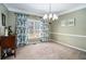 Traditional dining room with neutral carpet, chandelier and a window with floral drapes at 83 Southshore Ln, Dallas, GA 30157
