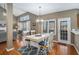 Bright dining area featuring hardwood floors, a stylish chandelier, and backyard access at 83 Southshore Ln, Dallas, GA 30157