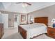 Main bedroom with a tray ceiling, carpeted floors and view to the bathroom at 83 Southshore Ln, Dallas, GA 30157