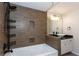 Stylish bathroom featuring a soaking tub with tiled wall and dual vessel sinks with granite countertops at 2229 Rugby Ave, Atlanta, GA 30337