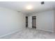 This bedroom has neutral paint, carpet, closet with an adjacent doorway to the landing at 2229 Rugby Ave, Atlanta, GA 30337