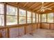 The sunroom is screened and has wood paneling, wood floor and a ceiling fan at 2229 Rugby Ave, Atlanta, GA 30337