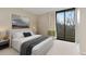 Comfortable bedroom with a large bed, soft textures, and a balcony offering scenic views at 2575 Peachtree Ne Rd # 10D, Atlanta, GA 30305