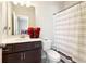 Bathroom features a dark vanity and a shower tub with a striped curtain at 2435 Folly Se Ln, Atlanta, GA 30339