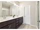 Bathroom features a double sink vanity, a large mirror, and a glass shower at 2435 Folly Se Ln, Atlanta, GA 30339