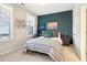 Cozy bedroom with a large bed, accent wall, and plenty of natural light from the windows at 2435 Folly Se Ln, Atlanta, GA 30339