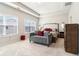 Bright main bedroom featuring a tray ceiling, carpet, and an abundance of natural light at 2435 Folly Se Ln, Atlanta, GA 30339